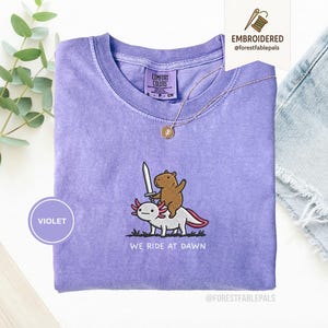 Embroidered Capybara Axolotl Shirt - We Ride at Dawn, Funny Capybara Shirt, Ren Faire Clothing, Cute Animal Gift, Medieval Shirt, CC 1717 Violet