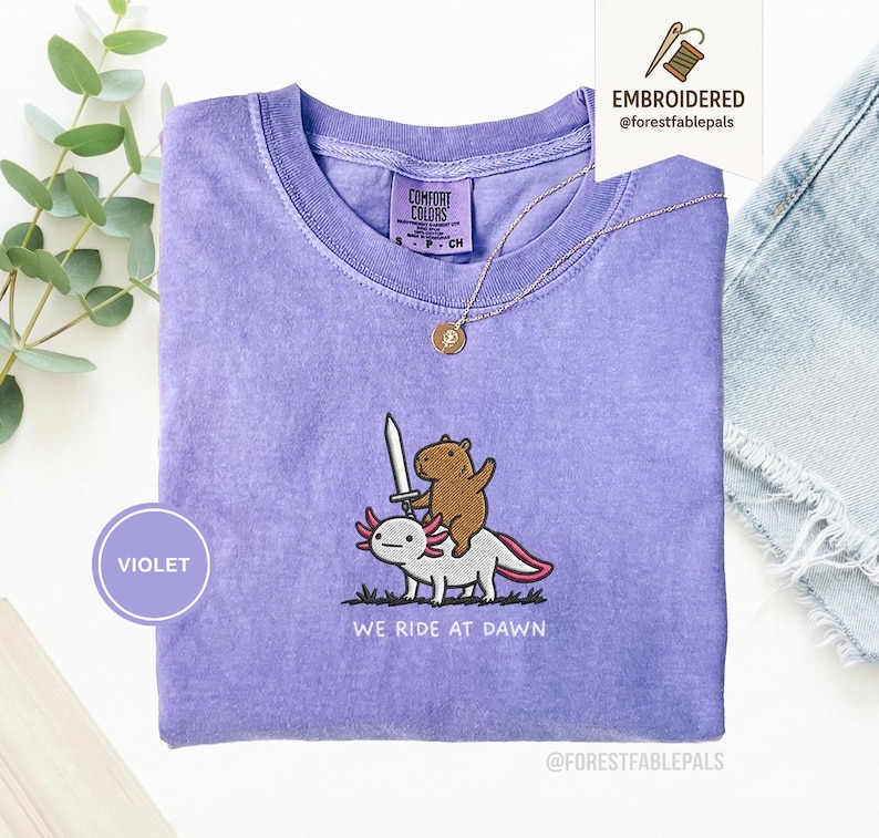 Embroidered Capybara Axolotl Shirt - We Ride at Dawn, Funny Capybara Shirt, Ren Faire Clothing, Cute Animal Gift, Medieval Shirt, CC 1717 Violet