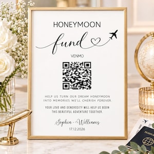 May include: A gold-framed sign featuring the text HONEYMOON fund, a heart, and an airplane icon. It includes a Venmo QR code, the names Sophia and Williams, the date 17.12.2026, and the message: HELP US TURN OUR DREAM HONEYMOON INTO MEMORIES.