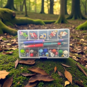 May include: A clear plastic organizer filled with pens, beads, and decorative charms. The charms feature cartoon characters. The pens are various colors, including red, blue, and green. The beads are in various colors and sizes. The organizer is on a bed of green moss.