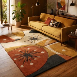 May include: A geometric patterned rug in a living room setting, featuring a colour palette of rust, cream, gold, and charcoal. The rug's design includes starburst and circular shapes. A mustard-coloured sofa and a potted plant are also visible in the room.