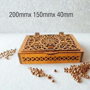 May include: A wooden box with intricate laser-cut floral patterns on the lid. The box is rectangular, approximately 7.9 inches long, 5.9 inches wide, and 1.6 inches high. Decorative gold-colored beads are scattered around the box.