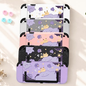 May include: Five rectangular gaming console protective cases stacked vertically, each featuring a purple cloud and star pattern with a small yellow character. The cases come in white, gray, pink, black, and purple, accompanied by four small colorful thumb grips.