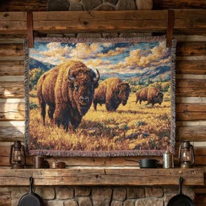 May include: A cozy living room with a stone fireplace and a tapestry depicting bison. The room features a leather sofa, wooden beams, and a warm fire. Two lanterns hang on the mantle, and the room has a rustic, cabin-like feel.