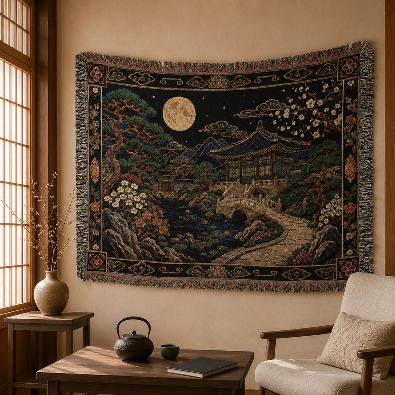 Korean palace tapestry wall hanging on a white background, showing a moonlit traditional garden with tiled pavilion, stone bridge, pond, pine tree, white blossoms, mountains, woven texture, and fringed edges.