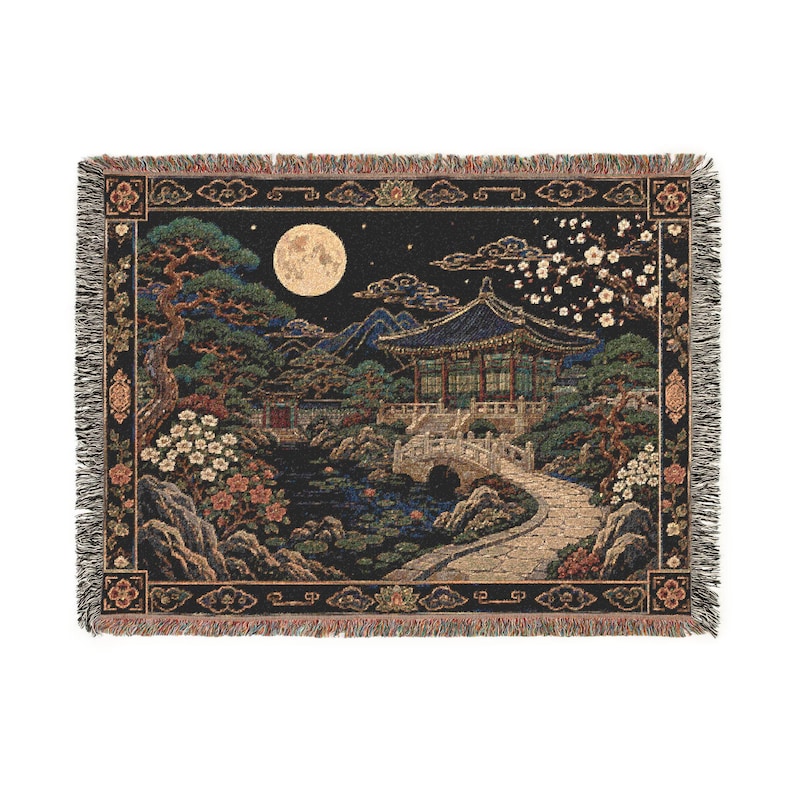 Korean palace tapestry wall hanging on a white background, showing a moonlit traditional garden with tiled pavilion, stone bridge, pond, pine tree, white blossoms, mountains, woven texture, and fringed edges.