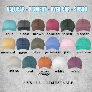 May include: A display of Valucap pigment-dyed SP500 baseball caps in various colors, including aqua, black, brown, cardinal, forest, maroon, mustard, navy, olive, periwinkle, pink, seafoam, stone, teal, Texas orange, white, and wine. Adjustable, with sizes 6 5/8 - 7 3/8.