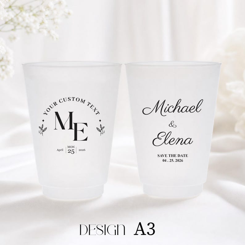 May include: Two frosted plastic cups with custom text and wedding details. One cup has "YOUR CUSTOM TEXT" and "ME" with the date "April 25 2026". The other cup says "Michael & Elena" and "SAVE THE DATE 04.25.2026".