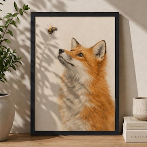 May include: A framed art print featuring a detailed illustration of a fox looking up at a bee. The fox has orange and white fur, with a black frame. The background is a neutral beige color.