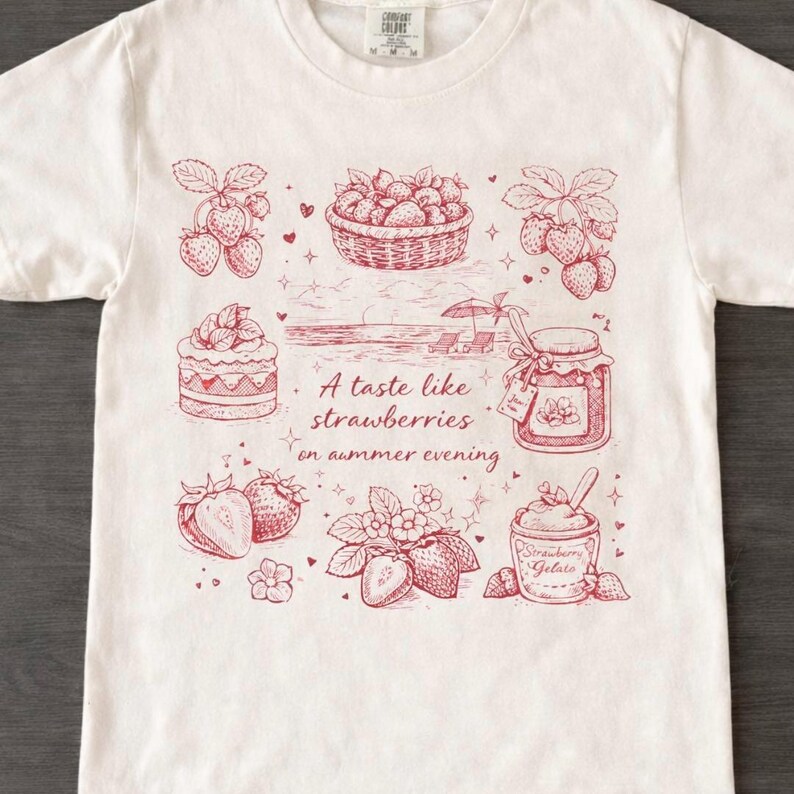 May include: White t-shirt with a red illustration of strawberries, a basket of berries, a cake, and a jar of jam. The text "A taste like strawberries on summer evening" is also printed on the shirt.