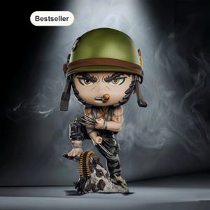 May include: A figurine of a cartoon character in a military helmet, holding claws. The figure is wearing a green helmet, a brown strap, and camouflage pants. The figure is standing on a rock with a belt of bullets.