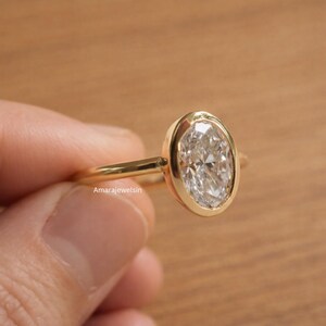 lab grown diamond ring
oval bezel engagement ring
2 carat lab diamond ring
bezel set diamond ring
cathedral engagement ring
IGI certified lab diamond
oval lab diamond solitaire
yellow gold bezel ring
minimalist engagement ring
modern bezel ring
low profile diamond ring
ethical diamond ring
lab diamond ring
gifts for women
gifts for her
gifts for sister
custom ring
cluster diamond ring
demi fine jewelry
elegant jewelry
timeless jewelry
minimalist ring
fine jewelry
proposal ring
signet ring