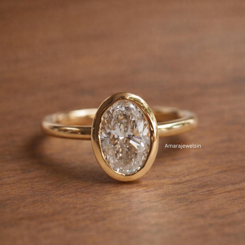 lab grown diamond ring
oval bezel engagement ring
2 carat lab diamond ring
bezel set diamond ring
cathedral engagement ring
IGI certified lab diamond
oval lab diamond solitaire
yellow gold bezel ring
minimalist engagement ring
modern bezel ring
low profile diamond ring
ethical diamond ring
lab diamond ring
gifts for women
gifts for her
gifts for sister
custom ring
cluster diamond ring
demi fine jewelry
elegant jewelry
timeless jewelry
minimalist ring
fine jewelry
proposal ring
signet ring