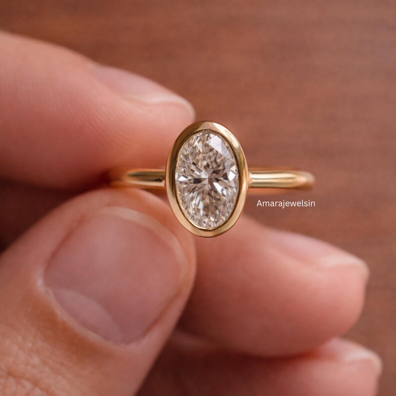 lab grown diamond ring
oval bezel engagement ring
2 carat lab diamond ring
bezel set diamond ring
cathedral engagement ring
IGI certified lab diamond
oval lab diamond solitaire
yellow gold bezel ring
minimalist engagement ring
modern bezel ring
low profile diamond ring
ethical diamond ring
lab diamond ring
gifts for women
gifts for her
gifts for sister
custom ring
cluster diamond ring
demi fine jewelry
elegant jewelry
timeless jewelry
minimalist ring
fine jewelry
proposal ring
signet ring