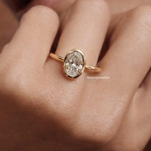 lab grown diamond ring
oval bezel engagement ring
2 carat lab diamond ring
bezel set diamond ring
cathedral engagement ring
IGI certified lab diamond
oval lab diamond solitaire
yellow gold bezel ring
minimalist engagement ring
modern bezel ring
low profile diamond ring
ethical diamond ring
lab diamond ring
gifts for women
gifts for her
gifts for sister
custom ring
cluster diamond ring
demi fine jewelry
elegant jewelry
timeless jewelry
minimalist ring
fine jewelry
proposal ring
signet ring