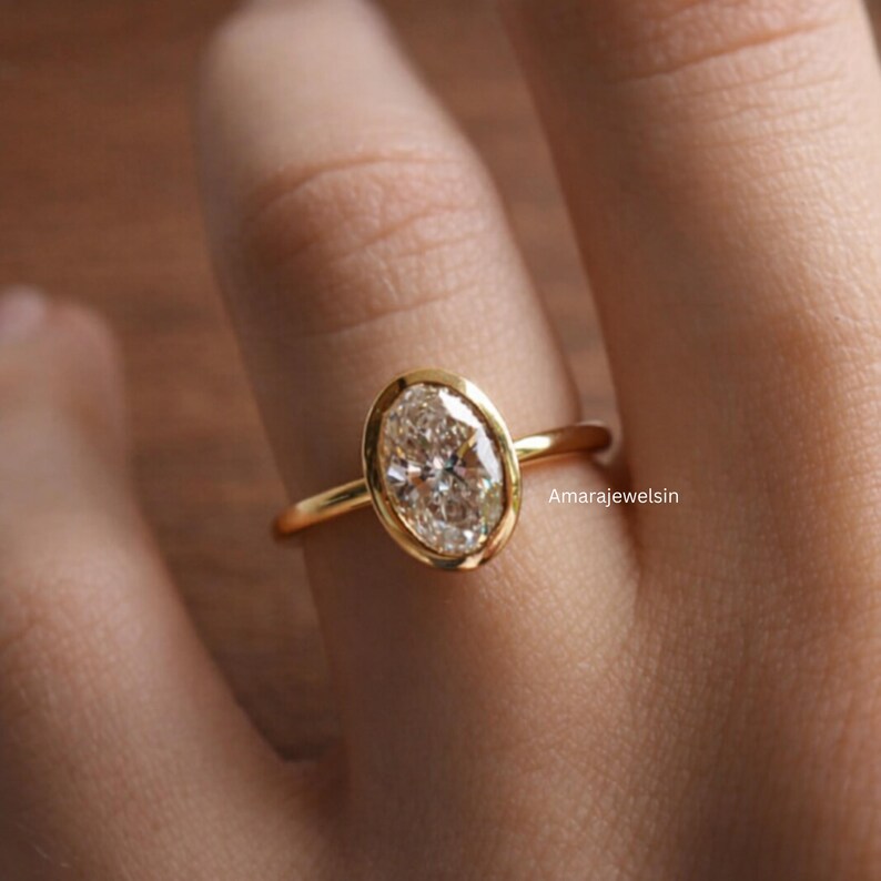 lab grown diamond ring
oval bezel engagement ring
2 carat lab diamond ring
bezel set diamond ring
cathedral engagement ring
IGI certified lab diamond
oval lab diamond solitaire
yellow gold bezel ring
minimalist engagement ring
modern bezel ring
low profile diamond ring
ethical diamond ring
lab diamond ring
gifts for women
gifts for her
gifts for sister
custom ring
cluster diamond ring
demi fine jewelry
elegant jewelry
timeless jewelry
minimalist ring
fine jewelry
proposal ring
signet ring
