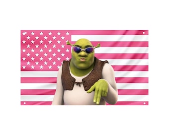 May include: A flag featuring a pink American flag design with a cartoon image of Shrek wearing sunglasses and a brown vest. The character is pointing down with one hand.