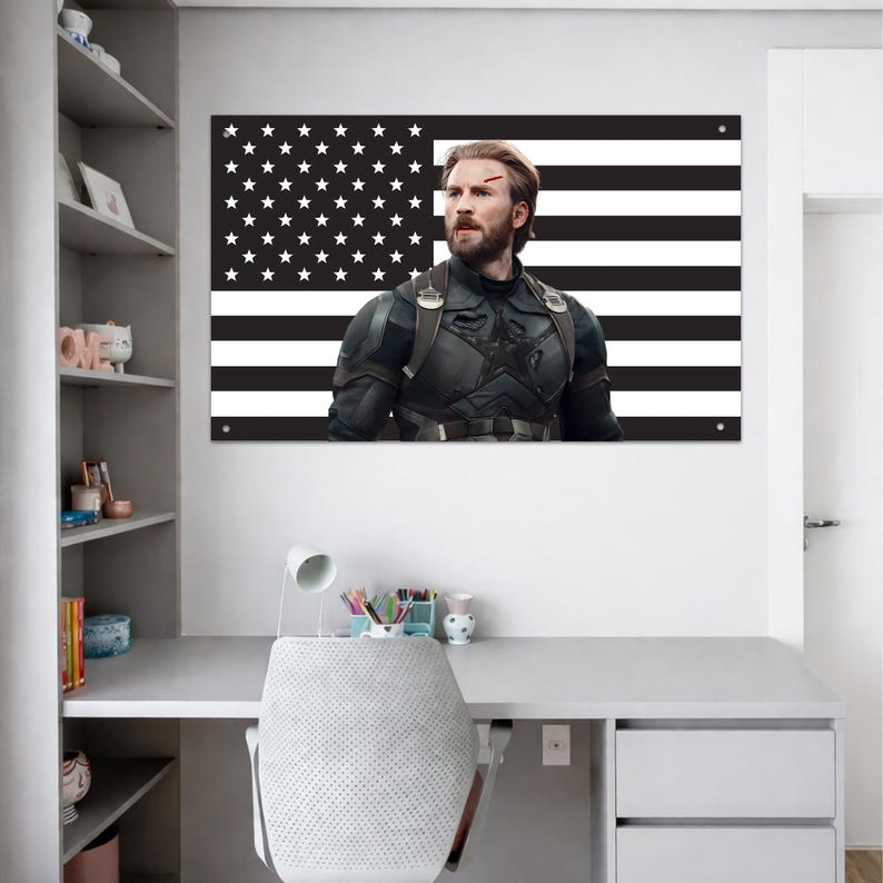 May include: A rectangular wall poster featuring a black and white American flag background with a centered portrait of a bearded man in a dark tactical suit with a star emblem on the chest, displaying a small red mark on his forehead.