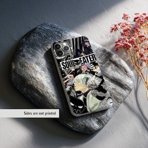 May include: A phone case featuring a black and white anime-style graphic with the text "SOUL EATER." The design includes various characters and elements from the series. The case is on a gray stone surface.