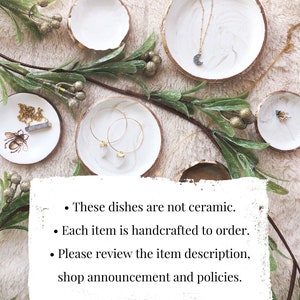 May include: White and gold-rimmed decorative dishes with jewelry, including a necklace with a crescent moon pendant and gold hoop earrings. Greenery and text are also present. The text says: These dishes are not ceramic. Each item is handcrafted to order. Please review the item description, shop announcement and policies.