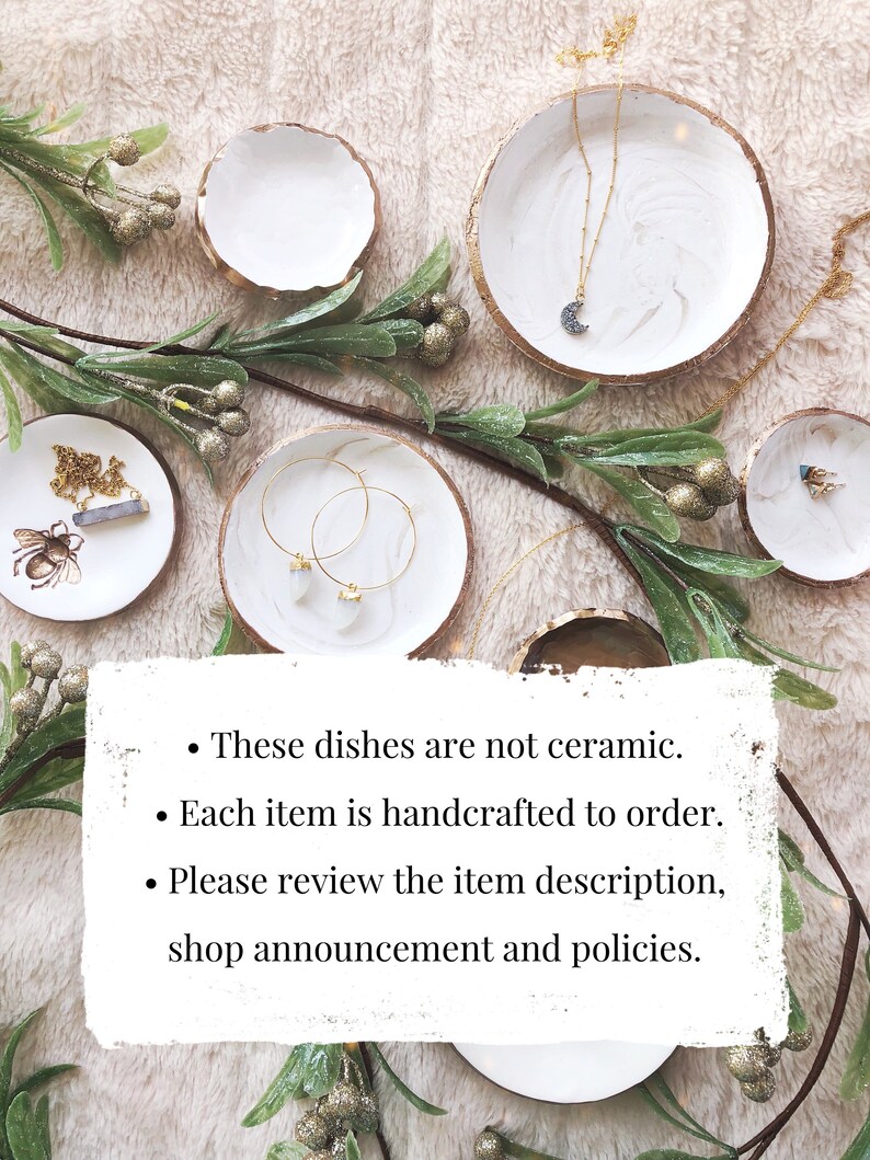 May include: White and gold-rimmed decorative dishes with jewelry, including a necklace with a crescent moon pendant and gold hoop earrings. Greenery and text are also present. The text says: These dishes are not ceramic. Each item is handcrafted to order. Please review the item description, shop announcement and policies.