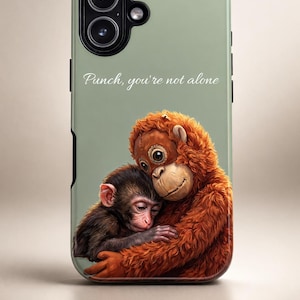 May include: A sage green phone case featuring a digital illustration of two monkeys embracing. The larger monkey has orange fur, and the smaller monkey has dark brown fur. The text "Punch, you're not alone" is written in cursive.