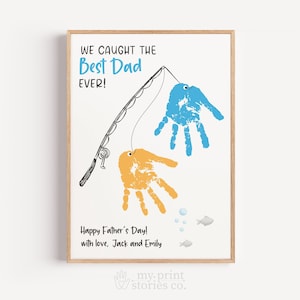 May include: A framed print with a light wood frame. The artwork features a fishing rod with blue and orange handprints as fish. Text reads "WE CAUGHT THE Best Dad EVER!" and "Happy Father's Day! with love, Jack and Emily."