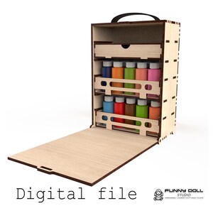 Puede incluir: Una caja de almacenamiento de pintura de madera con asa, abierta para revelar estantes con botes de pintura de colores. La caja tiene un cajón en la parte superior y un panel frontal plegable. El texto "Digital file" está en la parte inferior.