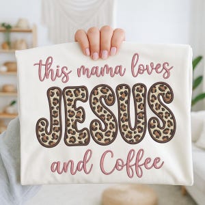 May include: A cream-coloured t-shirt with the text "this mama loves JESUS and Coffee" in pink script. The word JESUS is in a leopard print design with a brown outline.