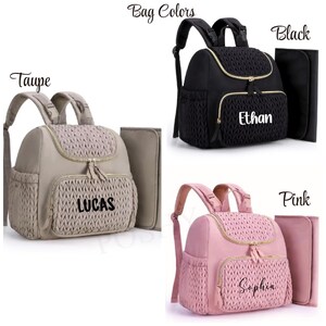 May include: Three diaper bags in taupe, black, and pink. Each bag has a woven front pocket and gold zippers. The taupe bag has "LUCAS" printed on it, the black bag has "Ethan", and the pink bag has "Sophia". Each bag includes a matching changing pad.