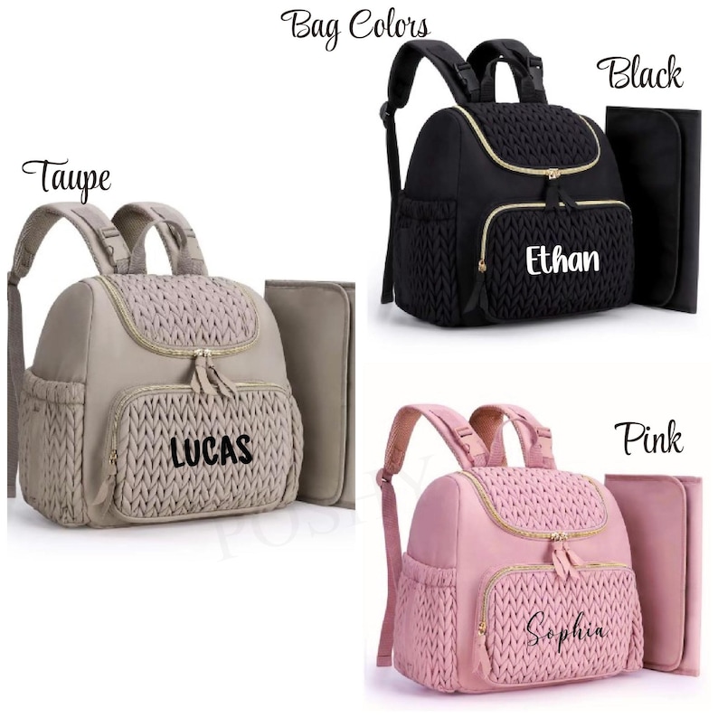 May include: Three diaper bags in taupe, black, and pink. Each bag has a woven front pocket and gold zippers. The taupe bag has "LUCAS" printed on it, the black bag has "Ethan", and the pink bag has "Sophia". Each bag includes a matching changing pad.