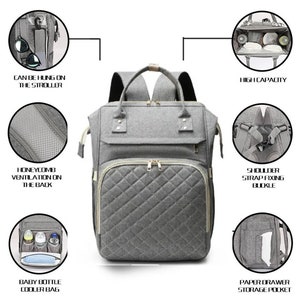 May include: Gray quilted diaper bag backpack with multiple compartments, including a baby bottle cooler bag and paper drawer storage pocket. Features include a honeycomb ventilation back, shoulder strap fixing buckle, and the ability to hang on a stroller.