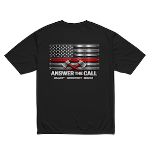 May include: Black t-shirt featuring a graphic of the American flag with a red stripe and crossed axes. The text "ANSWER THE CALL" is displayed below the flag, along with the words "BRAVERY - COMMITMENT - SERVICE."