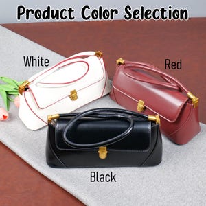 May include: Three rectangular handbags in white, red, and black, each with a gold-coloured clasp and handle accents. The image includes the text "Product Colour Selection" and labels each bag's colour.