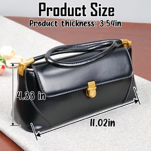 May include: Black handbag with a top handle and gold-coloured hardware. The bag is rectangular, with a flap closure and a handle. The product thickness is 9 cm, the height is 11 cm, and the length is 28 cm. The text "Product Size" is at the top.