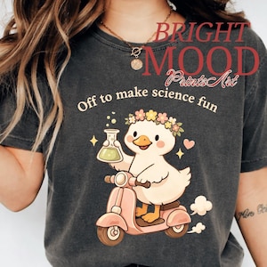 May include: A white ceramic mug with a black handle and the text "But First, Coffee" in a black, handwritten-style font. The mug is on a white surface.
