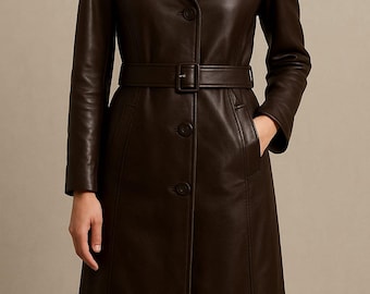 May include: A dark brown leather coat with a belted waist and button closure. The long coat features a notched collar, long sleeves, and pockets. The coat is a classic style, suitable for various occasions.
