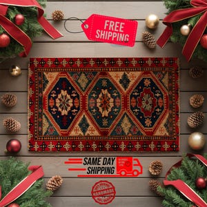 May include: A rectangular rug with a geometric pattern in red, navy blue, and beige. The rug features a central design with floral and diamond shapes. The image includes Christmas decorations and a tag that says "FREE SHIPPING".