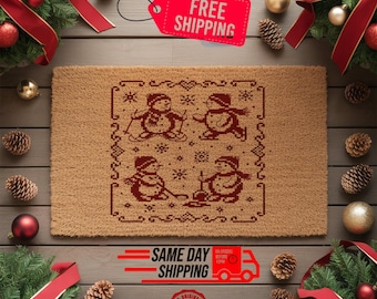 May include: A rectangular doormat with a brown background and a red snowman design. The design features four snowmen in various winter activities. The words "FREE SHIPPING" are on a red tag. The words "SAME DAY SHIPPING" are also visible.