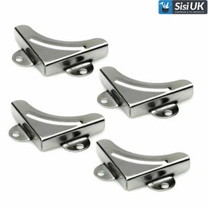 May include: Four polished metal corner protectors in a silver finish. Each has a curved shape with two small mounting holes. These are designed to reinforce and protect the corners of items like boxes or furniture. The image shows the reflective surface of the metal.
