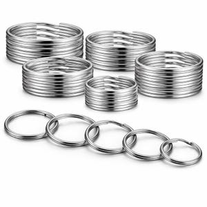 May include: A selection of silver split key rings, presented in stacks and individually. The key rings are made of metal and are arranged in stacks of different heights, with some rings shown separately.