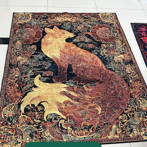 May include: A rectangular rug featuring a detailed illustration of a fox with a long, flowing tail. The fox is depicted in shades of orange, brown, and gold against a dark blue background with floral patterns. The word "Sample" is displayed in a green rectangle.