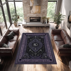May include: A large, rectangular area rug with a dark purple and black color scheme. The rug features a detailed, ornate design with celestial and occult symbols, including a crescent moon, keys, and stars. The rug is placed on a hardwood floor in a living room setting.