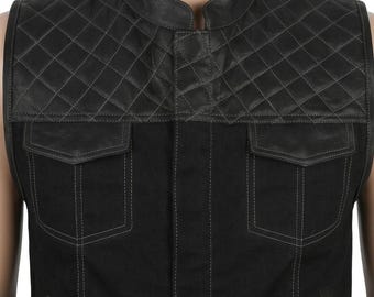 May include: A black sleeveless vest featuring a mandarin collar and a quilted leather upper panel. The lower section is made of a solid black fabric with two chest pockets, each with a flap closure and visible grey stitching throughout the garment.
