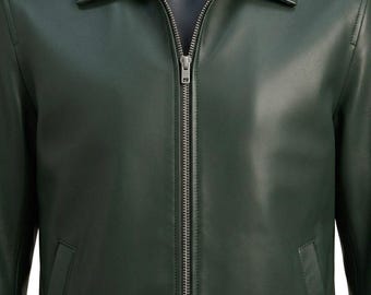 May include: A dark forest green leather jacket featuring a classic point collar, long sleeves, and a full-length silver-toned metal zipper closure down the center. The jacket includes two side pockets and visible stitching along the seams.