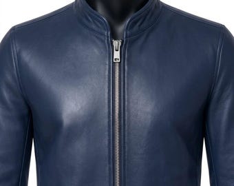 May include: A navy blue leather jacket featuring a stand-up collar and a full-length silver-toned metal zipper closure. The garment has a smooth, matte finish with visible stitching along the seams and a structured, fitted silhouette.
