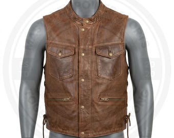 May include: A brown leather vest featuring a mandarin collar, a front snap-button closure, two chest pockets with snap-button flaps, and two lower zippered pockets. The sides of the vest include adjustable leather lace-up detailing for a secure fit.