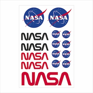 May include: Sheet of NASA logo stickers. The sheet includes multiple versions of the NASA logo, including the iconic blue circle with the white text and red swoosh, and the NASA wordmark in black and red.