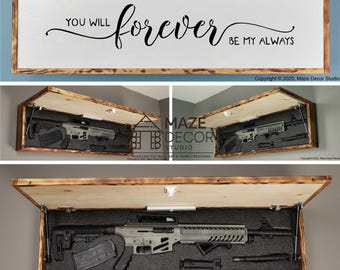 Puede incluir: Una caja de ocultación rectangular de madera para pared con acabado de bordes quemados. El panel frontal presenta el texto negro "YOU WILL forever BE MY ALWAYS". El interior contiene un rifle gris con cargador y accesorios en espuma.