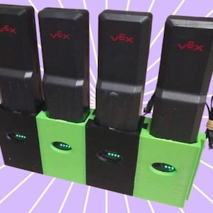 May include: A charging station with four black rectangular devices, each labeled "Vex" in red. The station alternates between black and green bases, each with an oval opening displaying green lights. The background has a purple and white striped pattern.